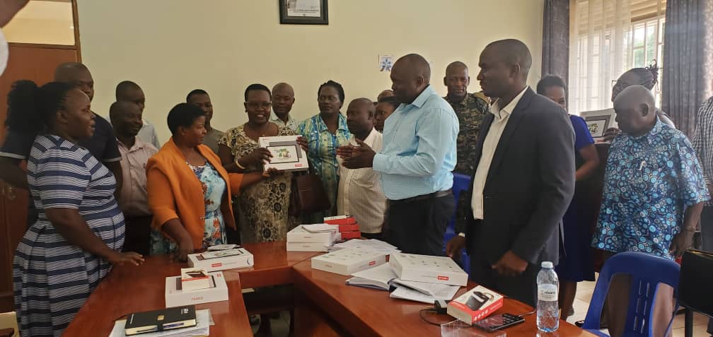 CDOs, parish chiefs and town agents receiving tablets from RDC - Kamuli and CAO - Kamuli, during a launch of the tablets from the Ministry of ICT & National Guidance for various activities and government programs. RDC - Kamuli and CAO - Kamuli launching tablets to be used by CDOs, parish chiefs and town agents in various government programs